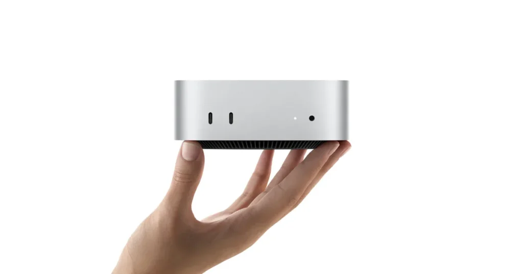Mac mini held in one hand